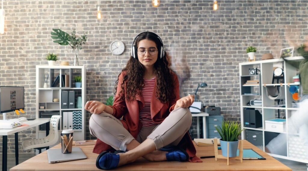 Persona meditando rodeada de tecnología, simbolizando el equilibrio entre inteligencia artificial y gestión emocional humana.